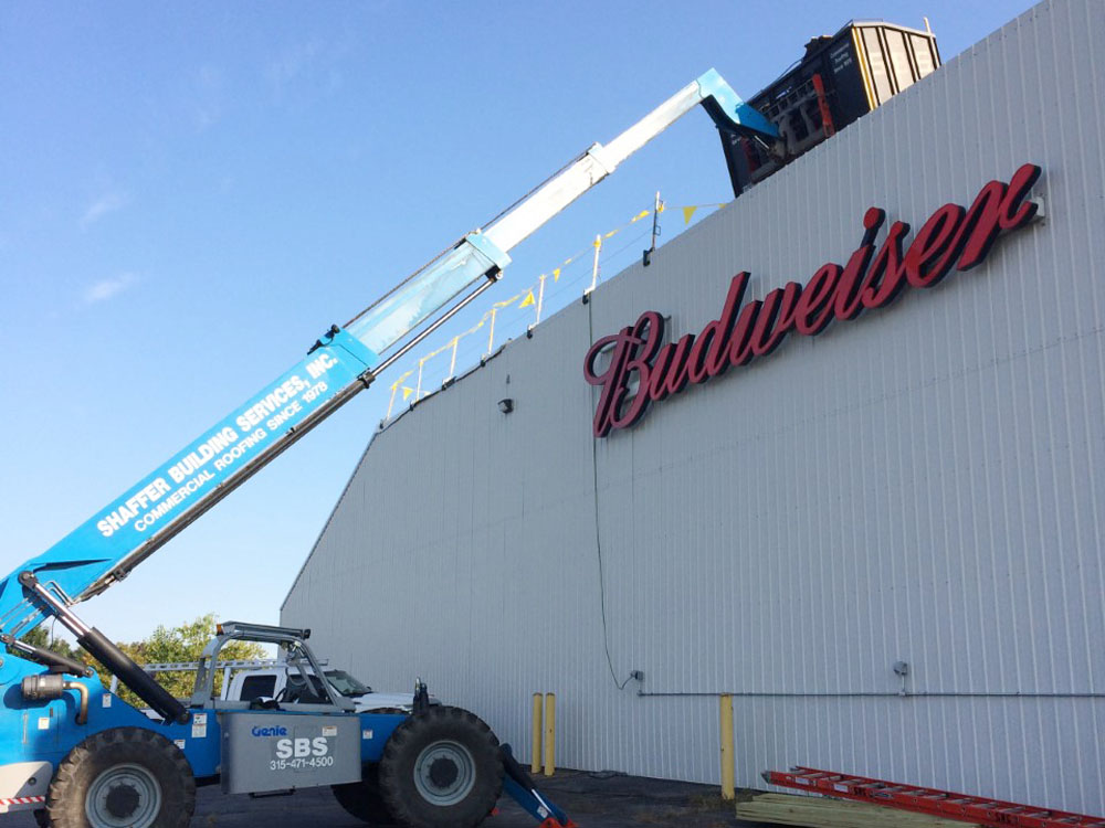 Loading roofing material by crane at the Budweiser plant, Liverpool NY
